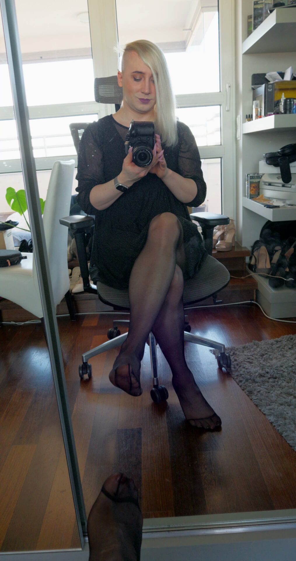 Sitting in black pantyhose in front of the mirror